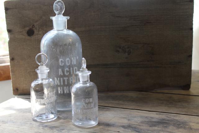 photo of old embossed glass bottles, antique apothecary pharmacy chemical bottle vintage lab glass #1