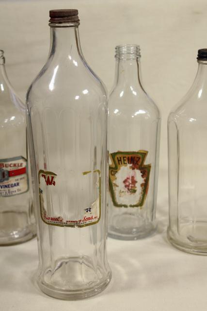 photo of old glass bottles, large vinegar bottle lot w/ some original paper labels #2