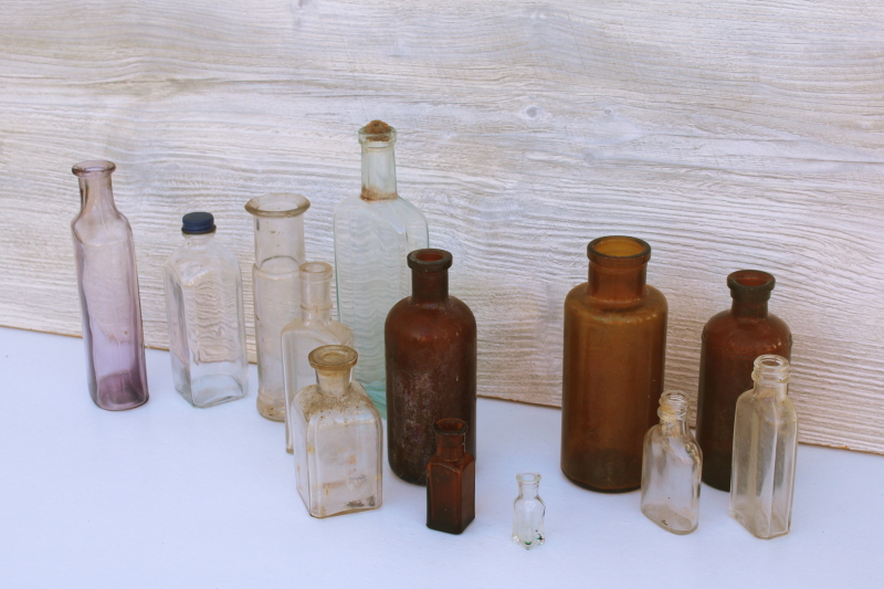 photo of old glass medicine bottles, amber brown, aqua, lavender tint clear glass vintage bottle lot #1