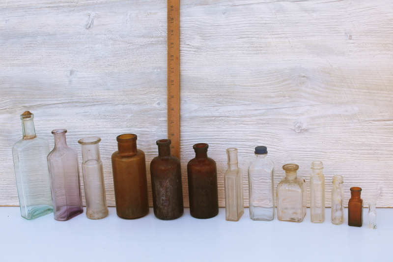 photo of old glass medicine bottles, amber brown, aqua, lavender tint clear glass vintage bottle lot #2