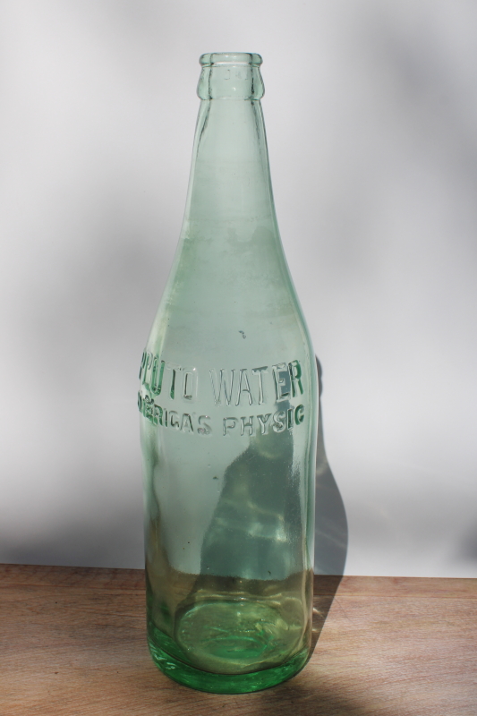 photo of old green glass bottle embossed devil Pluto tonic water vintage quack medicine #1