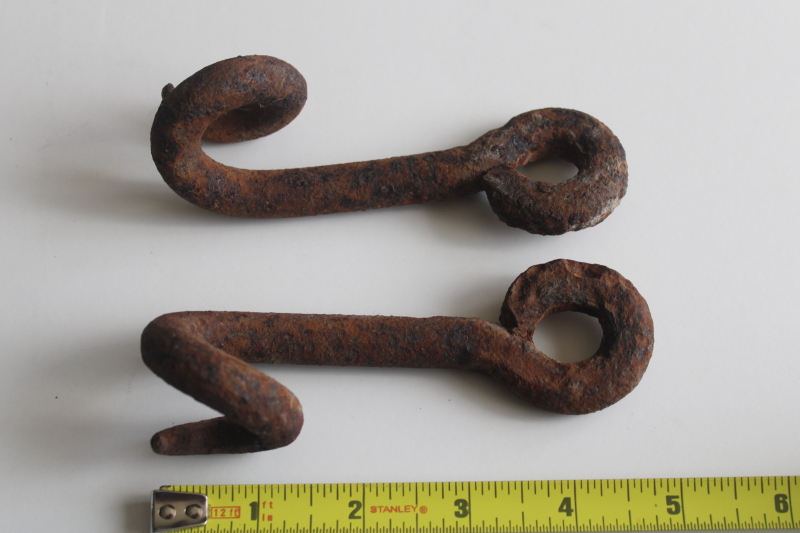 photo of old hand forged iron pigtail hooks, rusty antique hardware rope guides from farm equipment  #2