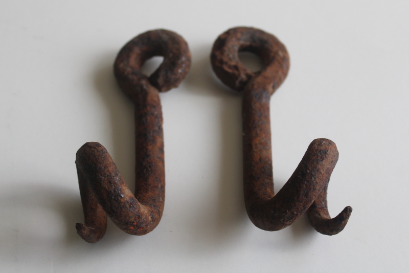 photo of old hand forged iron pigtail hooks, rusty antique hardware rope guides from farm equipment  #3