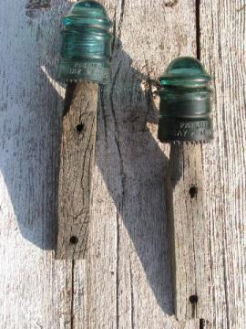 catalog photo of primitive harness or coat hooks, old barn board wood pegs w/ antique glass insulators