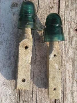 catalog photo of primitive harness or coat hooks, old barn board wood pegs w/ antique glass insulators