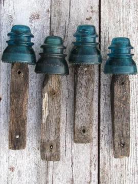 catalog photo of primitive harness or coat hooks, old barn board wood pegs w/ antique glass insulators