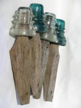 catalog photo of primitive harrness or coat hooks, old barn board wood pegs w/ antique glass insulators