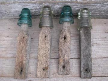 catalog photo of primitive harrness or coat hooks, old barn board wood pegs w/ antique glass insulators