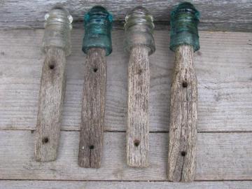 catalog photo of primitive harrness or coat hooks, old barn board wood pegs w/ antique glass insulators