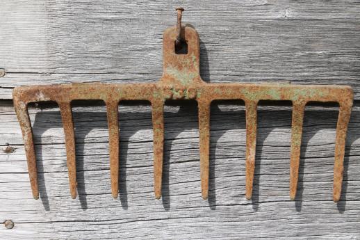 photo of primitive iron wall rack from rusty old cast iron grill part from wood burning or coal stove  #2