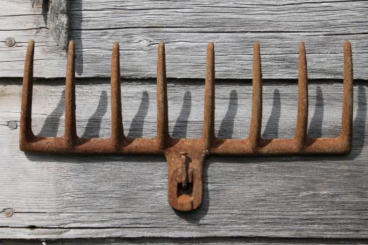 photo of primitive iron wall rack from rusty old cast iron grill part from wood burning or coal stove  #3