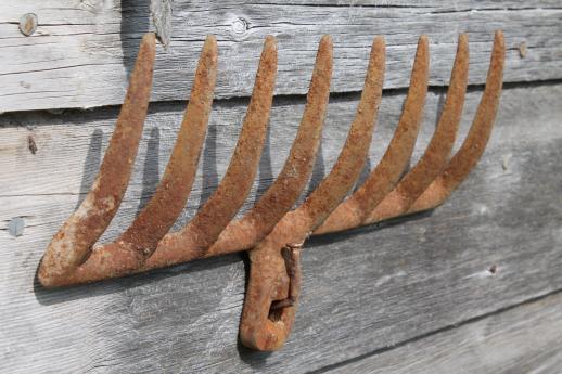 photo of primitive iron wall rack from rusty old cast iron grill part from wood burning or coal stove  #4