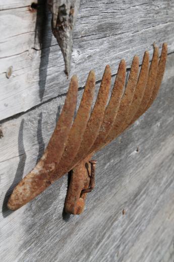 photo of primitive iron wall rack from rusty old cast iron grill part from wood burning or coal stove  #5