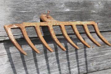 catalog photo of primitive iron wall rack from rusty old cast iron grill part from wood burning or coal stove 