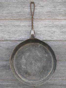 catalog photo of primitive old campfire or wood stove frying pan, skillet w/ wirework handle