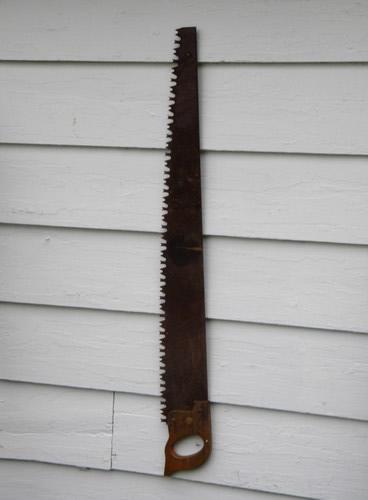 photo of primitive old crosscut saw lumberjack tool north woods cabin or lodge #1