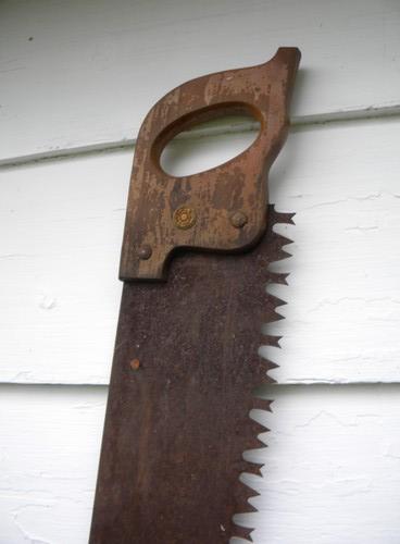 photo of primitive old crosscut saw lumberjack tool north woods cabin or lodge #2