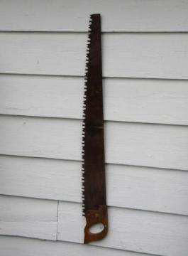 catalog photo of primitive old crosscut saw lumberjack tool north woods cabin or lodge