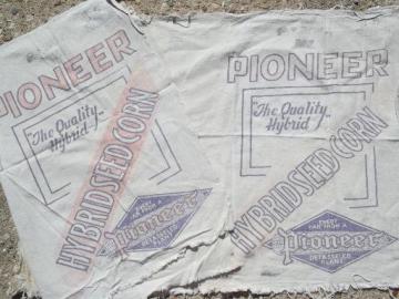 catalog photo of primitive old farm seed corn grain sacks, vintage Pioneer graphics