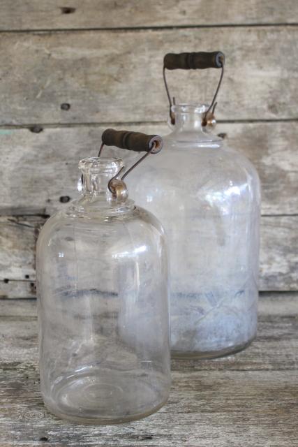 photo of primitive old glass half & gallon bottles, moonshine jug jars w/ wire bail wood handles #1