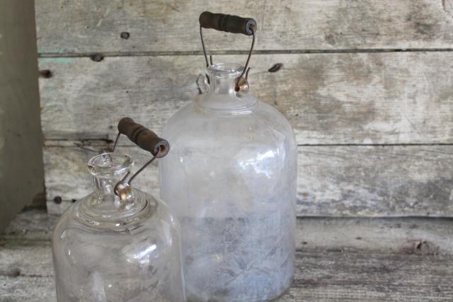 photo of primitive old glass half & gallon bottles, moonshine jug jars w/ wire bail wood handles #2