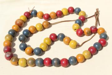 catalog photo of primitive vintage counting string, big round wood beads, wooden beads in primary colors
