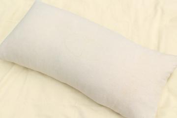 catalog photo of primitive vintage feather pillow, long heavy bolster in homespun cotton grainsack 