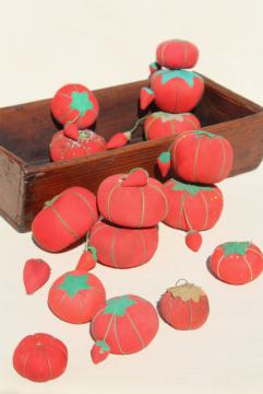 catalog photo of red tomato pincushions, vintage pin cushion collection in primitive wood box bowl