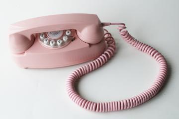 photo of retro style pink princess phone, touch tone 2015 Crosley remake of vintage telephone