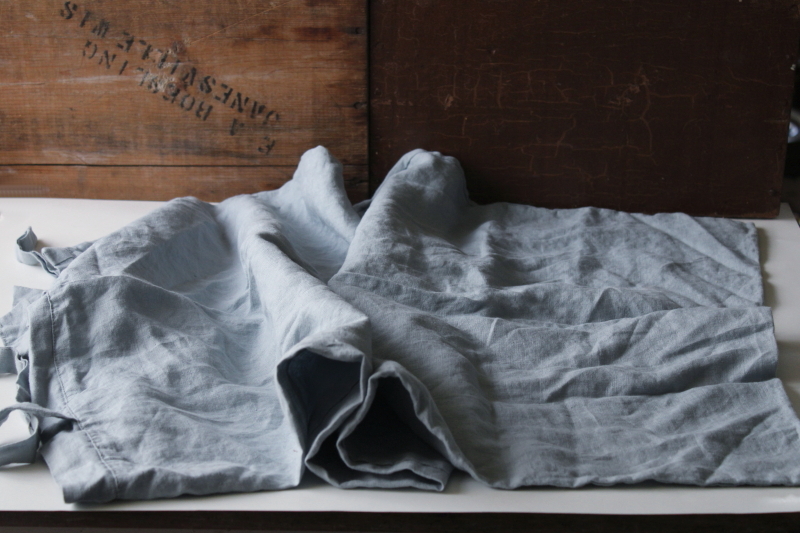 photo of rumpled washed linen pillowcase w/ ties, pure linen fabric soft chambray blue color #5