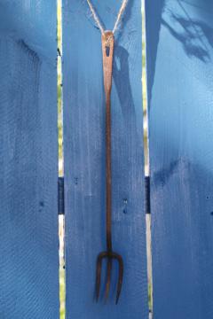 catalog photo of rustic antique forged iron toasting fork for fireplace or campfire cooking