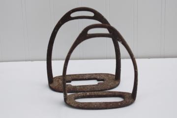 photo of rusty crusty old antique metal stirrups, vintage horse tack for display or repurpose
