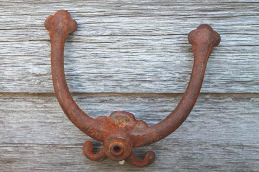 photo of rusty old antique iron coat hook, ornate vintage cast iron hardware double hook #3