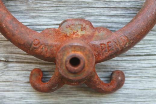 photo of rusty old antique iron coat hook, ornate vintage cast iron hardware double hook #4