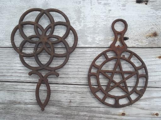 photo of rusty vintage cast iron trivets, star in circle & large flower #1