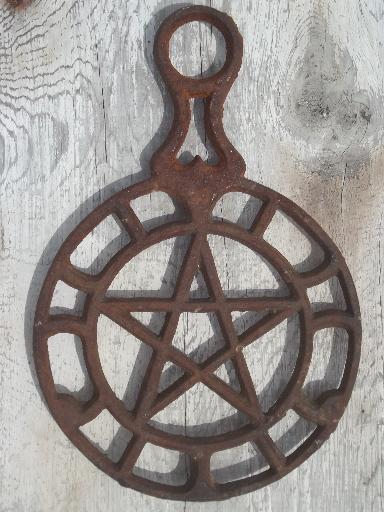 photo of rusty vintage cast iron trivets, star in circle & large flower #2