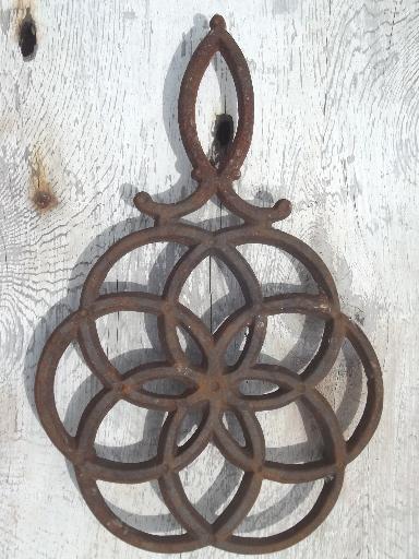 photo of rusty vintage cast iron trivets, star in circle & large flower #3