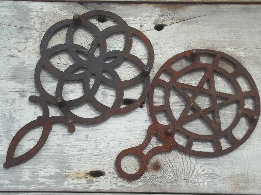 photo of rusty vintage cast iron trivets, star in circle & large flower #4