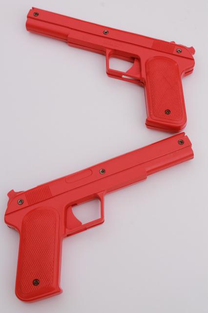 photo of sci-fi style vintage red plastic rubber band shooters, toy guns pair of pistols #1