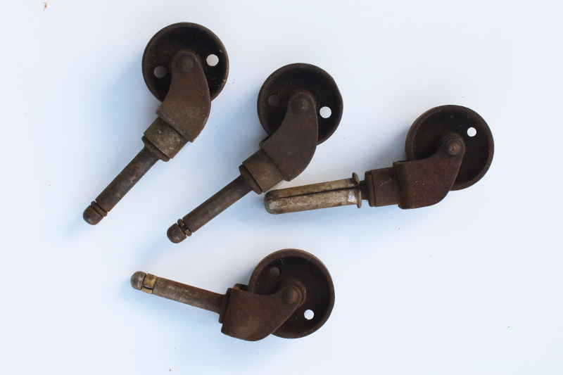 photo of set of four antique iron wheels furniture casters vintage industrial steel hardware #1