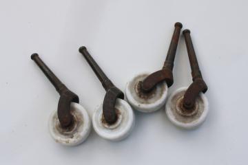 catalog photo of set of four matching white porcelain wheel casters, antique vintage restoration hardware