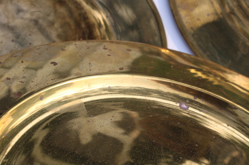 photo of set of six vintage solid brass chargers, large plates 11 and 3 quarters diameter heavy brass under plate trays #6