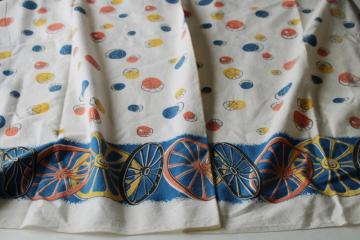 catalog photo of shabby faded vintage cotton feed sack fabric, western wagon wheels border print 