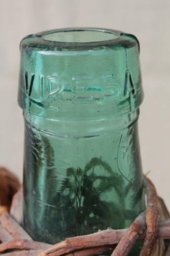 photo of shabby vintage basket covered bottles, lot of old green glass wine bottles in baskets #2