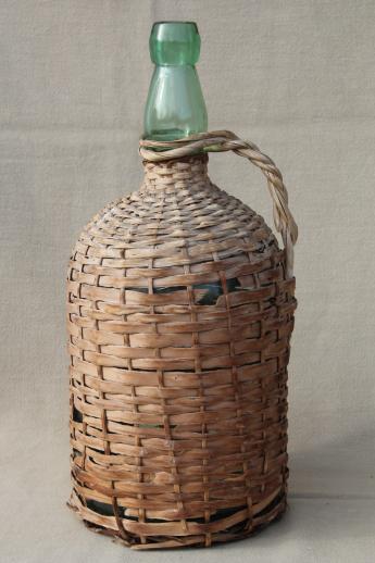 photo of shabby vintage basket covered bottles, lot of old green glass wine bottles in baskets #5