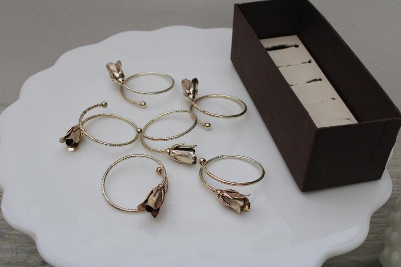 photo of silvery metal bangle style napkin rings, flower buds or roses on narrow bracelet #2