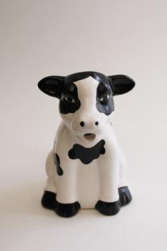 photo of sitting holstein cow creamer, black & white spotted cow pitcher 1980s vintage