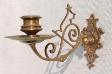 catalog photo of small ornate brass candle sconce, swing pivot arm w/ metal wall mount bracket