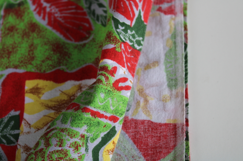 photo of soft cotton fabric w/ Africa ethnic print, people & palm trees in greens & red block print style #3
