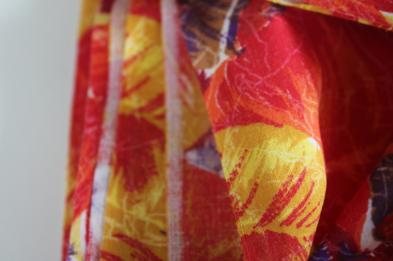photo of soft cotton fabric w/ tropical palm leaves print in bold colors red, yellow, purple, brown #3